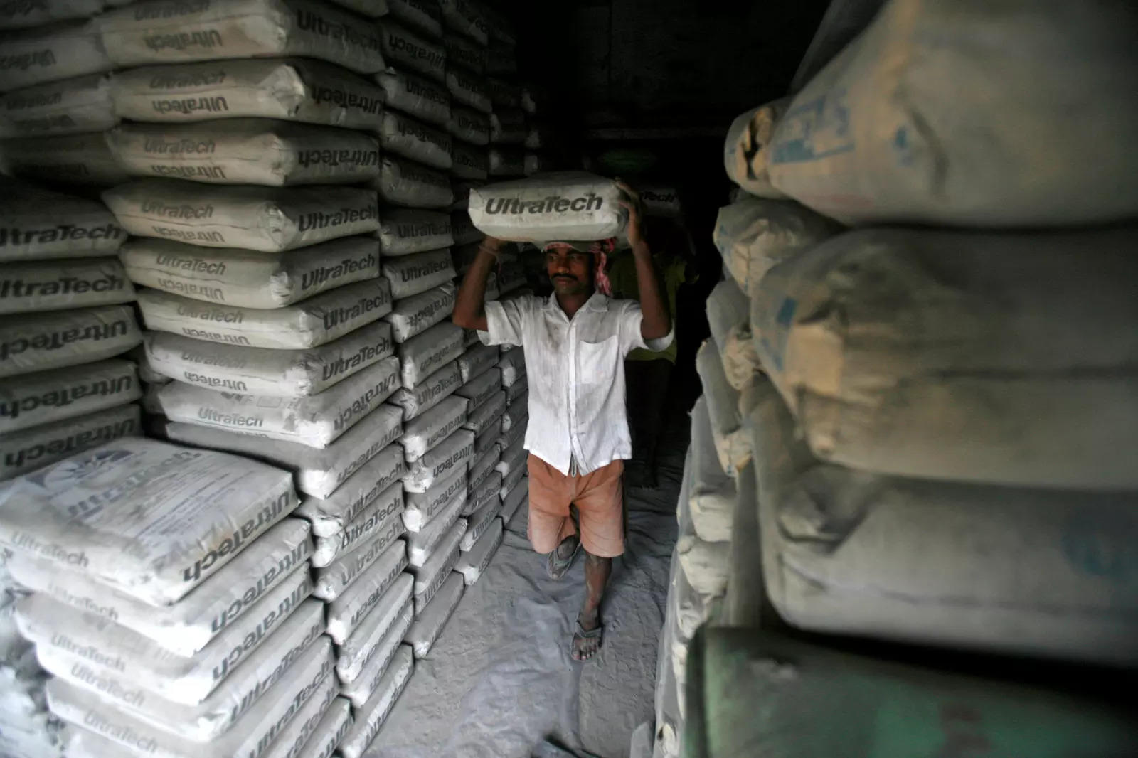 Warehouse helper loading cement bags for dispatch